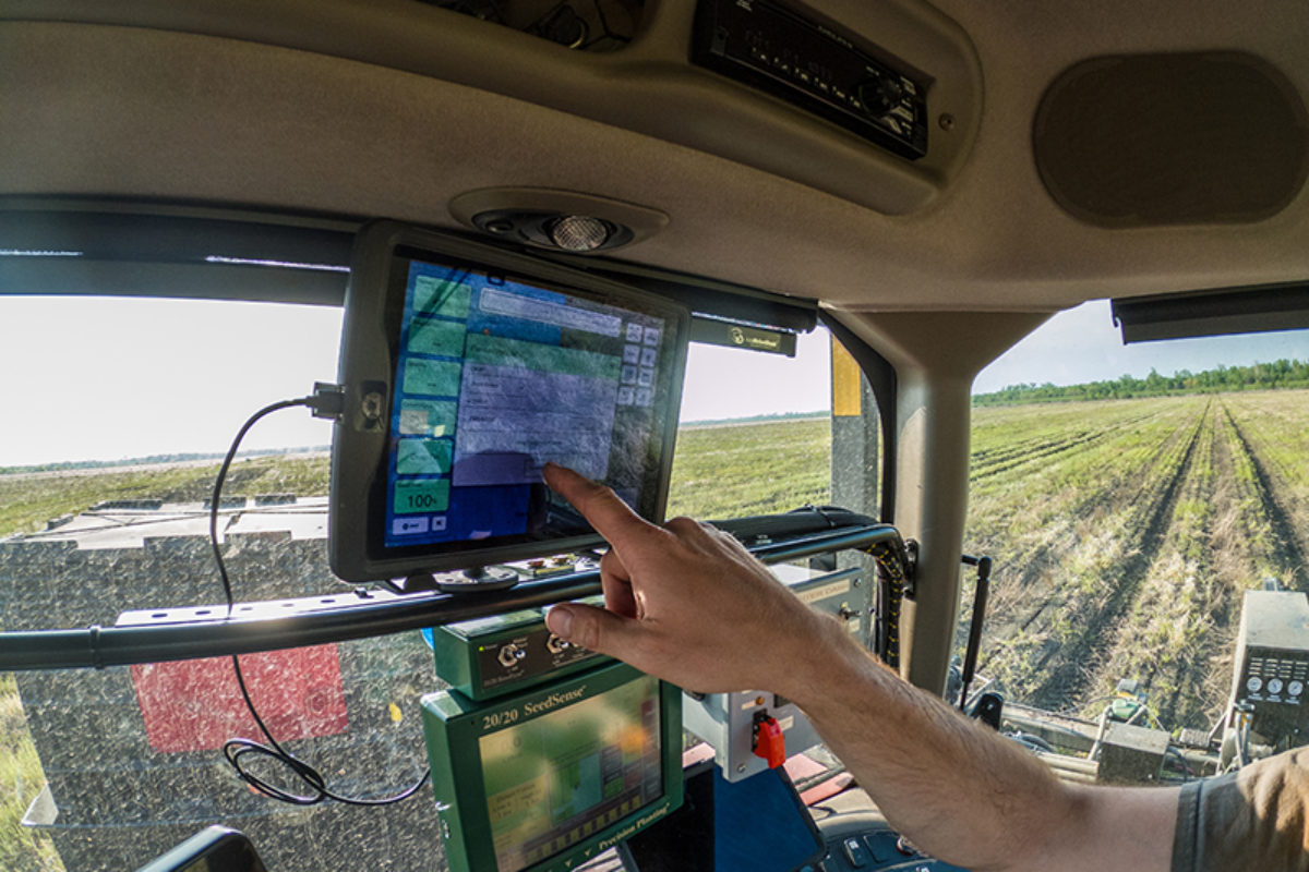 Farmer Using Precision Ag Monitor During Planting