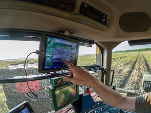 Farmer Using Precision Ag Monitor During Planting