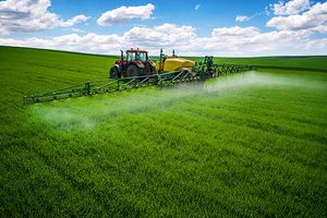 Agricultural sprayer over small grain