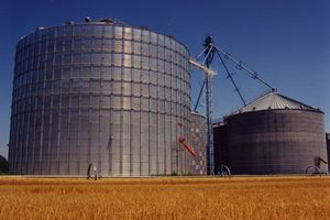 Two grain bins with blue skies