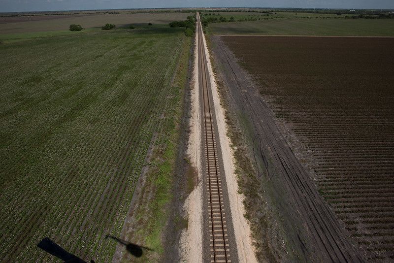 Empty train tracks with field on both sides