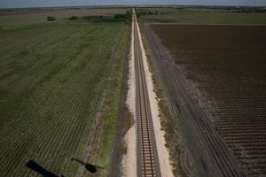 Empty train tracks with field on both sides