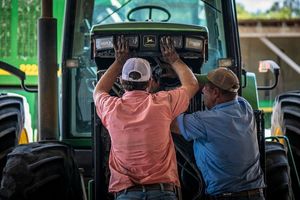 Schirmer Farms (Batesville) Operations Manager Brandon Schirmer, assisted by farm owner and father Ernie Schirmer, puts their tractor back together, near San Antonio, TX, on August 11, 2020. They are performing needed farm equipment repairs and maintenance in preparation for the upcoming cotton harvest.