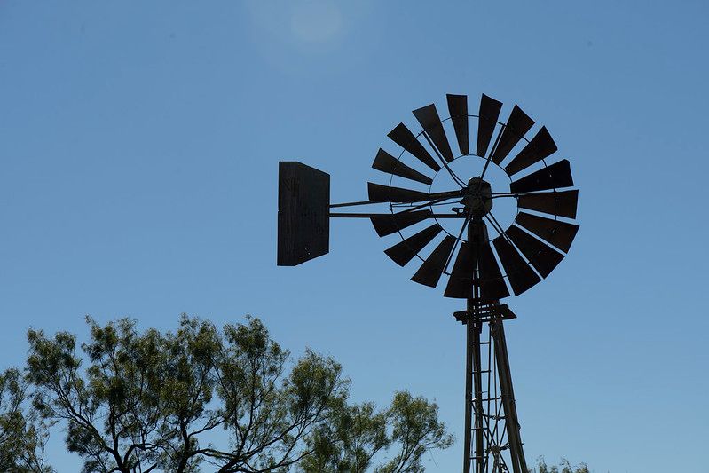 Wind mill against a blue sky on a farm in Texas