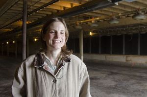 Female farmer standing in new chicken barn